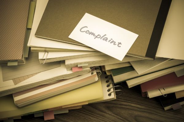 Who may file a complaint against a licensed professional